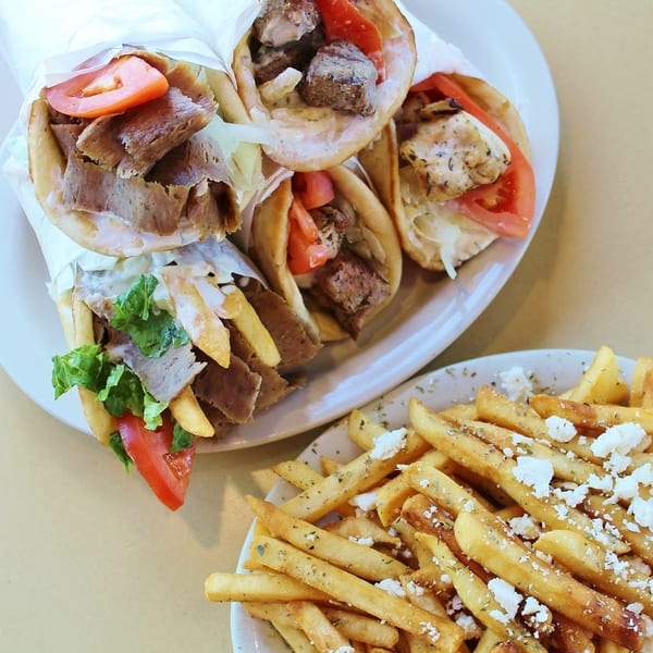Plates of Hub's Restaurant's gyros and chicken pita sandwiches with a side of feta cheese fries.